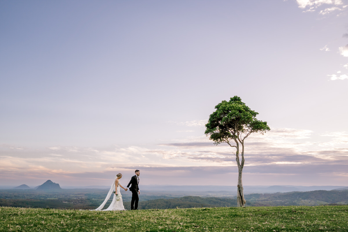 Maleny wedding photographer couple walking hand in hand glasshouse mountains sunshine coast