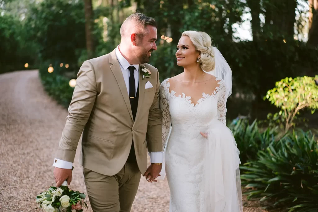 bride and groom walking down the beautiful lane towards gabbinbar homestead toowoomba